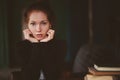 Close up indoor portrait of beautiful thoughtful redhead woman with freckles