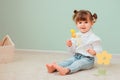 Indoor portrait of cute happy baby girl playing with easter decorations Royalty Free Stock Photo