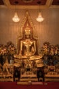 Close up indoor shiny golden buddha statue in buddhist temple in