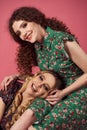 Close up indoor studio fashion portrait of gorgeous women in stylish floral dresses. Blonde and brunette girls isolated Royalty Free Stock Photo