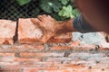 Close up of industrial bricklayer installing bricks on construction site