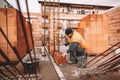 Close up of industrial bricklayer mason installing bricks