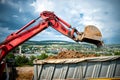 Close-up of industrial excavator loading a dumper truck