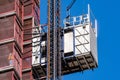 Close up of industrial hoist used to lift workers and materials at a construction site