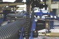 Close-up of industrial machinery with chains, pipes, bolts and movable elements