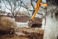 Close up of industrial mini excavator scoop moving earth and doing landscaping works Royalty Free Stock Photo