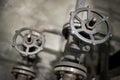 Close-up of industrial pair of valves with focus on foreground ventil with inscription open and close on helm and direction Royalty Free Stock Photo