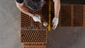 Close up of an industrial worker making wall with mortar and bricks, using hammer and level tool. Stock footage. Male Royalty Free Stock Photo
