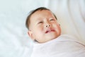 Close up Infant baby boy crying and screaming lying on bed