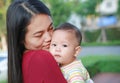 Close-up Infant baby boy is sucking finger with Asian mother carrying Royalty Free Stock Photo