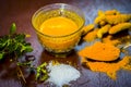 Close up of ingredients of ayurvedic treatment of cough i.e. turmeric,Curcuma longa,salt,sodium chloride,and oil.