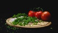 Close-up of ingredients on wooden cooking board on black isolated background. Frame. Handful of green fragrant parsley