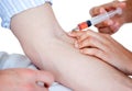 Close up of an injection in a man's arm Royalty Free Stock Photo