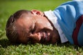 Close up of injured rugby player lying on field Royalty Free Stock Photo