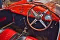 Close-up of the inside and the steering wheel of a red classic rally car