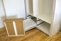 Close up of installation of wooden drawer in contemporary cupboard cabinet