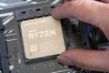 Close-up of installing third generation Ryzen processor on mainboard Royalty Free Stock Photo