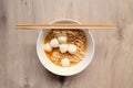 Close up Instant noodle with meatballs on wooden background. Royalty Free Stock Photo