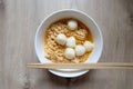 Close up Instant noodle with meatballs on wooden background. Royalty Free Stock Photo
