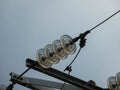 Close up of insulator power lines against blue sky Royalty Free Stock Photo