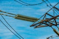 Close-up of insulators on the wires of a tower of a high-voltage power line Royalty Free Stock Photo