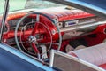 Close up interior of a classic retro / vintage car, steering wheel clock, dashboard, speedometer.