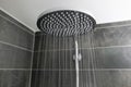 Close-up interior stylish shower spraying water