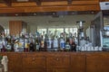 Close up interior view of bar with different sorts of alcohol and coffee machine.