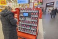 Close up interior view of ICA supermarket. Female customer in front of stand with electronic scanners.