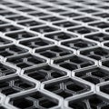 Close-up of an interlocking hexagonal metal grid. The structure features a repeating, Royalty Free Stock Photo