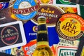 Close up of international beer coaster boards from all over the world with yellow bottle