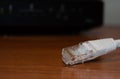 Close up of internet cable on wooden table with modem in the background Royalty Free Stock Photo