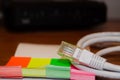 Close up of internet cable on wooden table with modem in the background Royalty Free Stock Photo