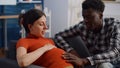 Close up of interracial couple with pregnancy at home Royalty Free Stock Photo