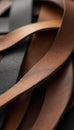 Close-up of intertwined leather strips in various brown and dark tones. Abstract texture and pattern formed by weaving material. Royalty Free Stock Photo
