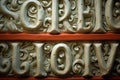 A close-up of intricate Latin letter bas-relief on an ancient wall.