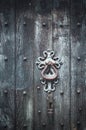 a close up of an ornate metal latch on a wooden door Royalty Free Stock Photo
