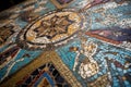 close-up of intricate mosaic tile design, with the colors and shapes coming to life