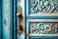 A close-up of an intricately designed antique door painted in a distressed blue color. The door features a bronze handle with Royalty Free Stock Photo