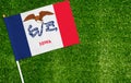 Close-up of Iowa flag against closed up view of grass