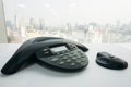 Close up IP conference phone with wireless speaker on table