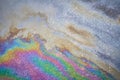 Close-up of an iridescent oil or gasoline spill on a wet asphalt, viewed from above. Royalty Free Stock Photo