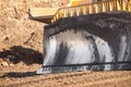 Close up of an iron excavator bulldozer bucket with parts soil for loading