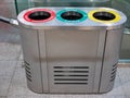 Close-up of an iron garbage can. Sorting garbage into plastic, paper and unsorted waste is marked with different colors. Cleaning