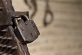 Close-up of iron padlock of ancient torture chair in sunlight