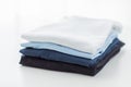 Close up of ironed and folded t-shirts on table Royalty Free Stock Photo