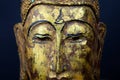 Close up of isolated ancient gold paint wood Buddha head face of thai statue in buddhist temple Royalty Free Stock Photo