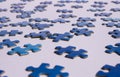 Close up of isolated blue puzzle pieces, white background Royalty Free Stock Photo