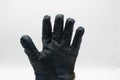 Close up of isolated dirty protection leather glove showing five fingers, white background