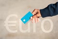 Close up of isolated euro credit or debit card. Woman hand with credit card